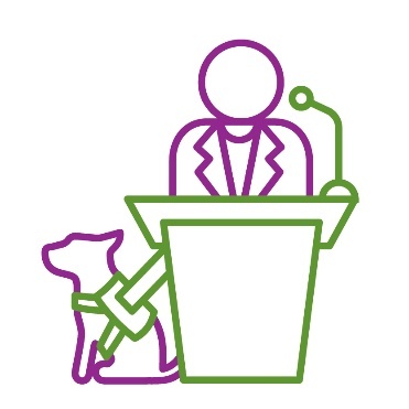 A person with a service dog standing at a podium.