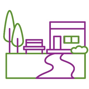 A park with a bench and a path leading to a building.