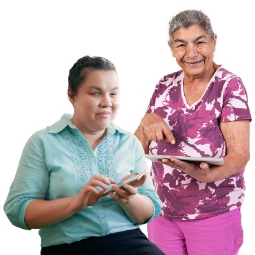 A person with vision impairment using a phone next to someone using a tablet.